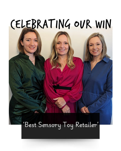 three women who are sisters standing together and smiling in celebration of winning an award for best sensory toy retailer
