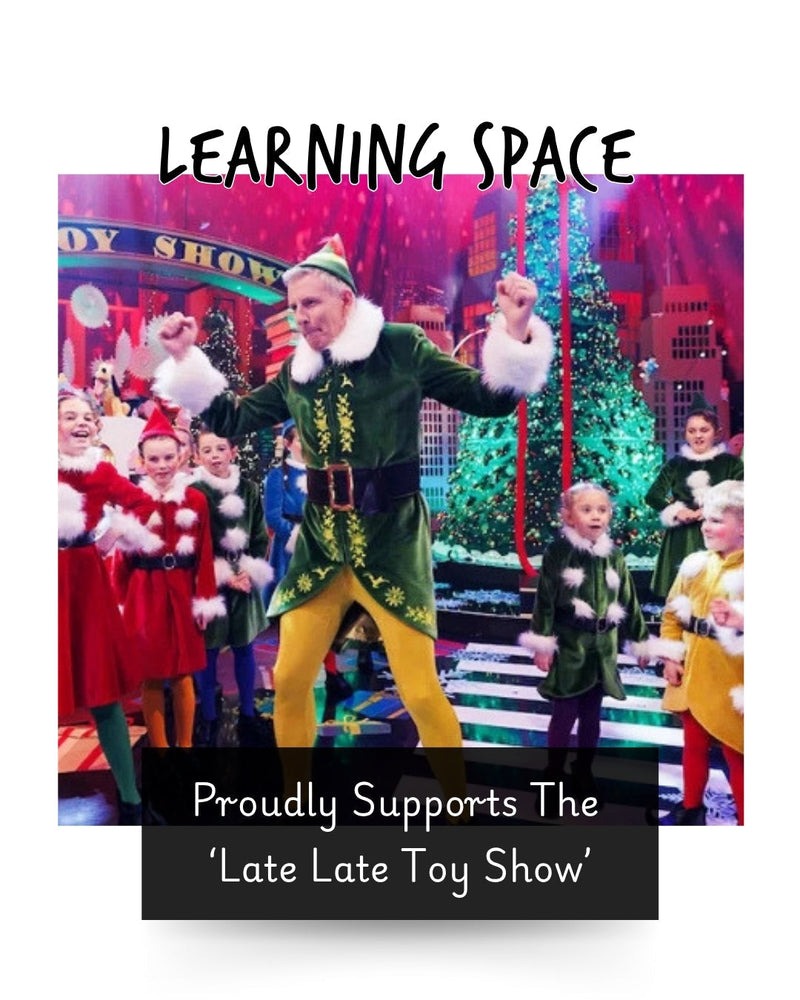 the late late toy show host dressed as an elf with children behind him dressed as elves and Santa for a Christmas toy tv show