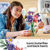 A young builder arranging the LEGO Olivia Rodrigo's Flower Bouquet in a vase, with its iconic butterflies and black hearts
