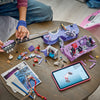 LEGO Olivia Rodrigo's Dual Guitar opened on a table showing the hidden dressing room scene, minifigures, spare parts and the LEGO Builder app on a tablet
