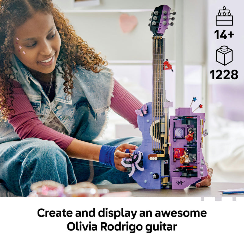 Girl holding the built LEGO Olivia Rodrigo's Dual Guitar, a 1,228-piece building set for ages 14+
