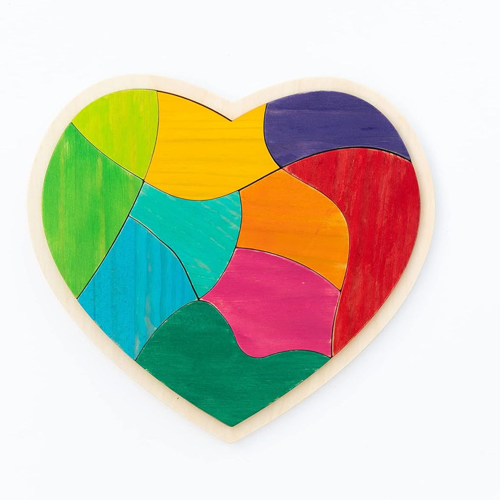 A heart-shaped wooden jigsaw puzzle with colorful painted pieces in green, yellow, blue, purple, red, orange, and pink, set against a plain white background.