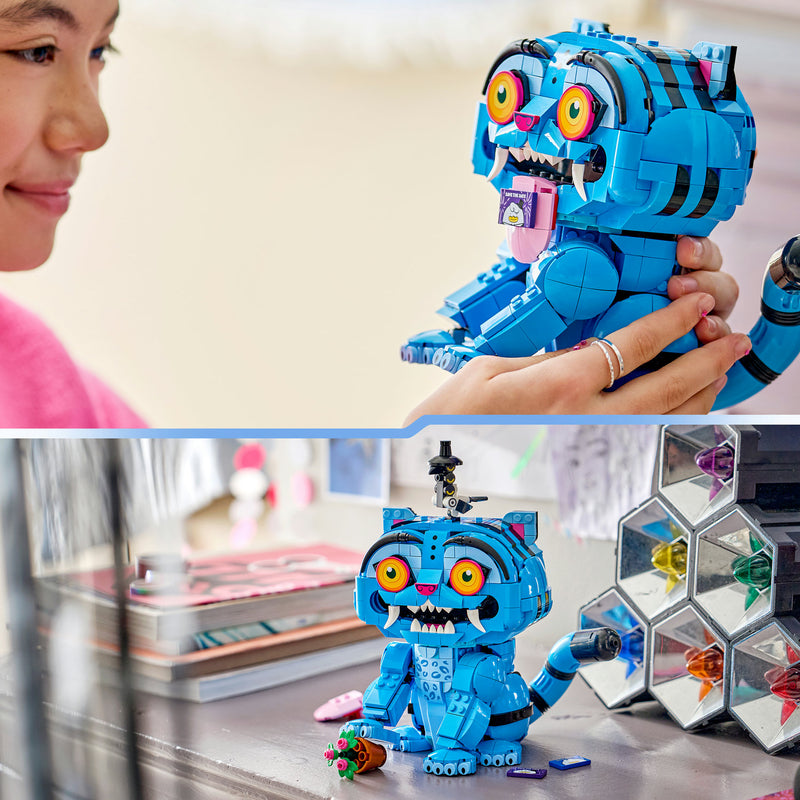 Girl holding the LEGO Derpy Tiger figure, with Derpy displayed on a desk beside Sussie Bird
