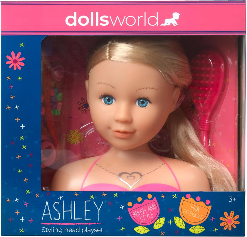 Dolls World Ashley styling head playset in its original retail packaging, featuring a blonde doll with blue eyes and a pink top, with a pink hairbrush and other accessories visible inside.