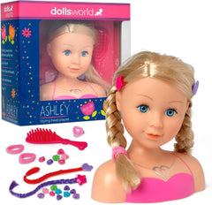 Dolls World styling head player set featuring a blonde doll bust with braided hair, pink top, and accessories including a pink comb, hair clips, rings, and colorful beads, shown next to its blue and pink retail box on a white background.