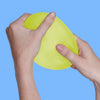 Hands squeezing the lime green Speks Gump Jumbo memory gel stress ball
