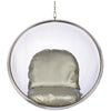 A modern hanging bubble chair with a clear acrylic dome, a polished silver metal frame, and a padded seat cushion in a champagne-gold fabric, suspended by a chain against a plain white background.