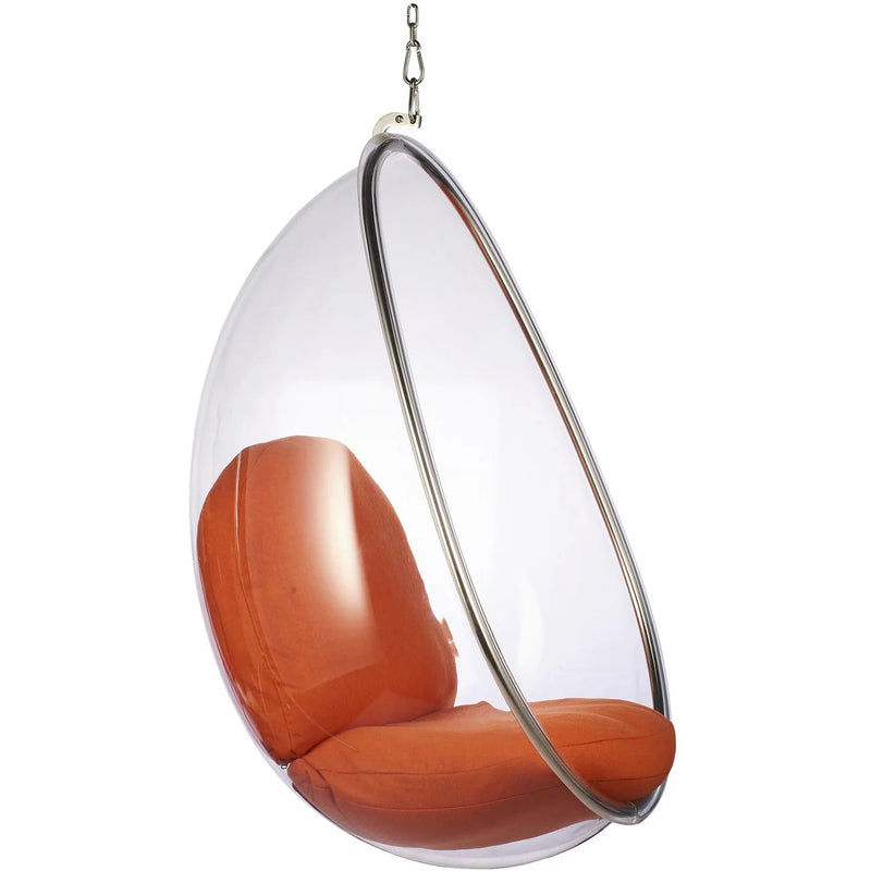 A modern hanging egg chair with a clear transparent dome shell, a silver metal frame, and orange-brown cushioned seat and backrest, suspended by a chain against a white background.