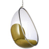 A modern hanging egg chair with a clear transparent shell and olive green cushioned seat and backrest, suspended by a metal chain with a silver frame.