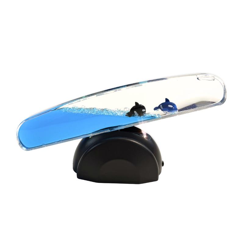 ight Up Whale Seesaw with two whale figures in blue liquid, tilted with the left end lowered