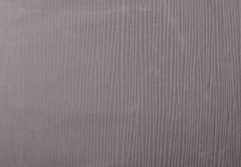 A close-up of a textured fabric with vertical ribbed stripes in a muted grayish-purple tone.