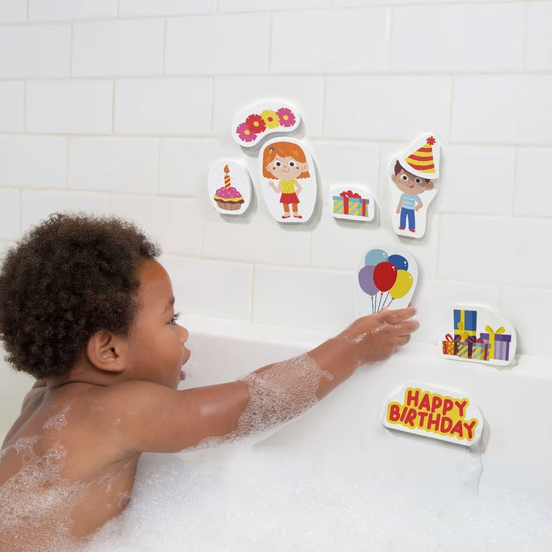 Child placing a balloon-shaped foam piece on the tiled bath wall beside birthday characters, presents and decorations