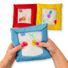 Hands pressing a blue Sensory Touch and Search Bag to move the filling and reveal shapes