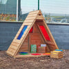 Sky View Forest Fern playhouse in an outdoor reading area with display accessories