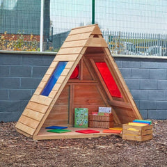 Sky View Forest Fern playhouse in an outdoor reading area with display accessories