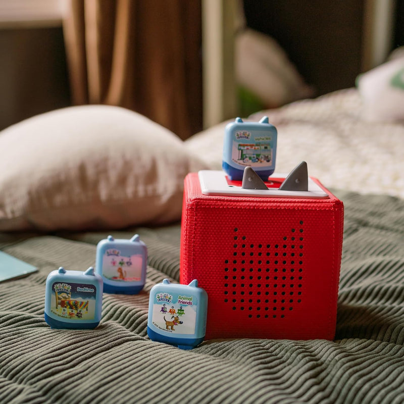 Four Alphablocks Clever Pocket Tonies beside and on a red Toniebox, sold separately