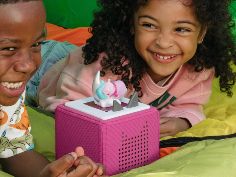 Two children listening to Peppa’s Bedtime Stories Tonie on a pink Toniebox, sold separately