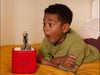 Child listening to The Nightmare Before Christmas Tonie on a red Toniebox