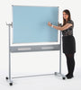 Woman writing on a standing dual-sided whiteboard with a light blue writing surface.