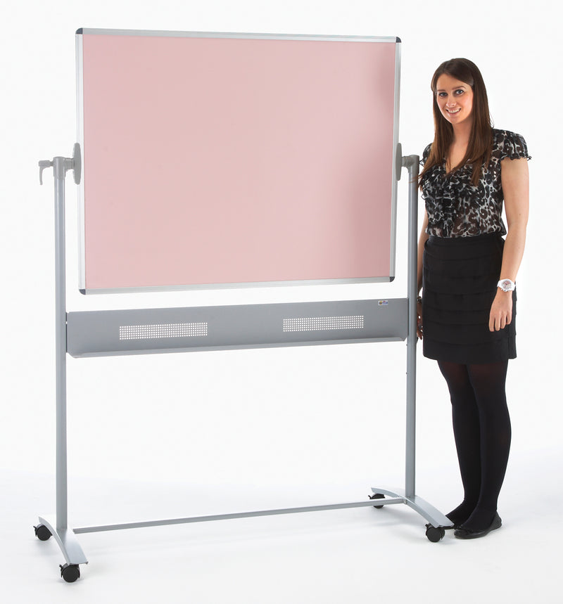 Woman standing next to a large portable whiteboard with a pink colour on a white background