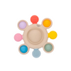 Colorful baby teething ring with various textures on a white background